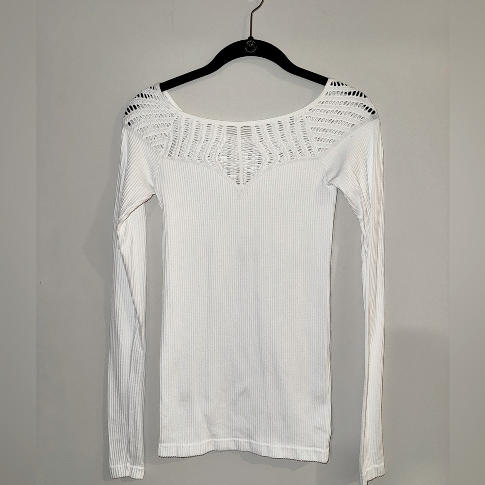 Free People white top with cutout detail around décolletage, shoulders and back.